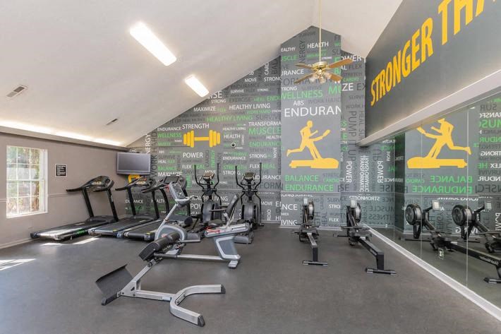 a gym with a bunch of exercise equipment in it