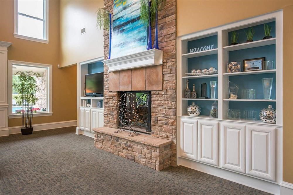 a living room with a fireplace and a painting on the wall