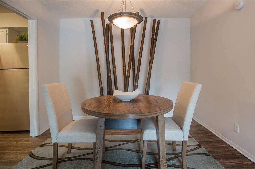 a dining room with a table and chairs and a lamp