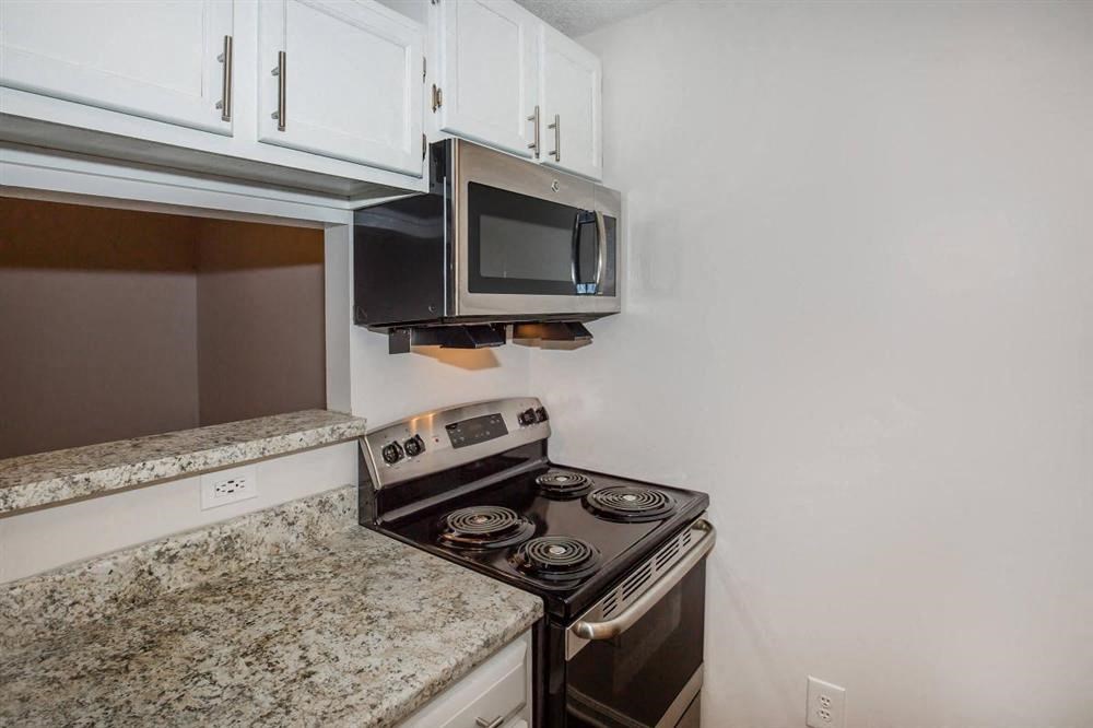 a kitchen with a stove and a microwave