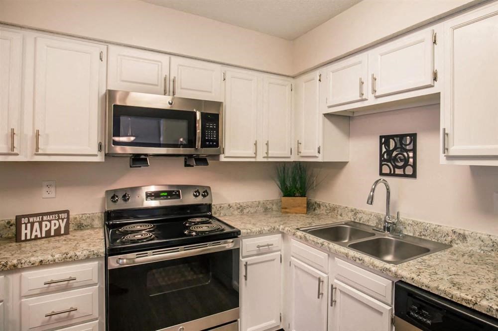 a kitchen with stainless steel appliances and white cabinets
