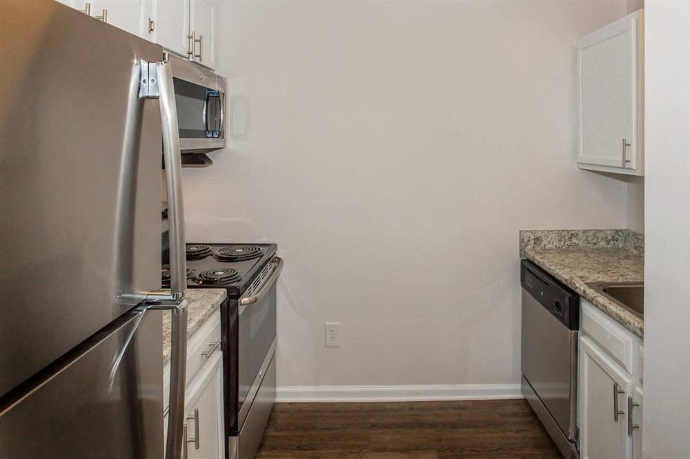 a kitchen with stainless steel appliances and white cabinets