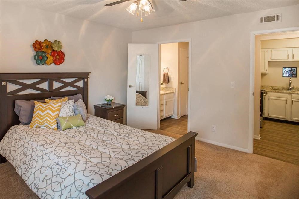 a bedroom with a bed and a view of the bathroom