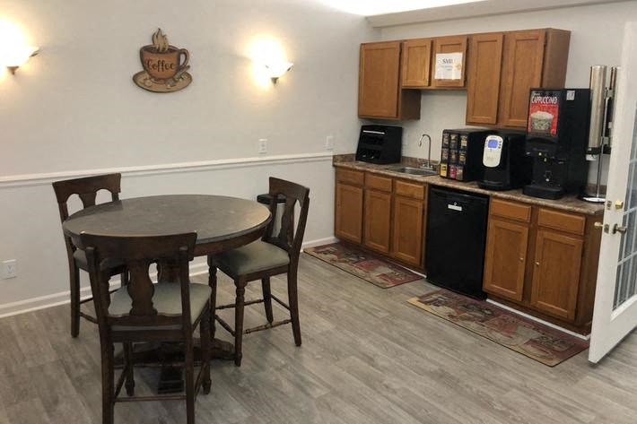 a kitchen with a dining table and a refrigerator