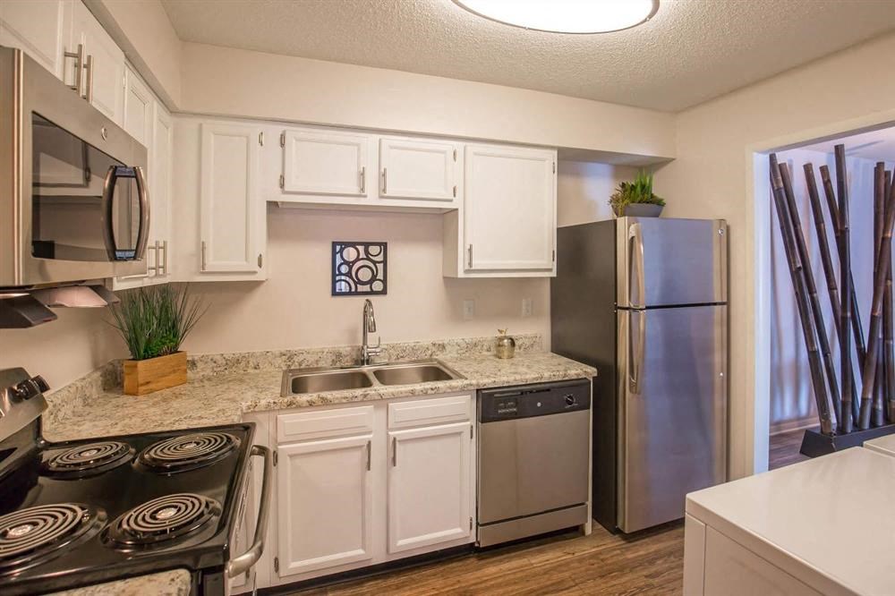 a kitchen with stainless steel appliances and white cabinets