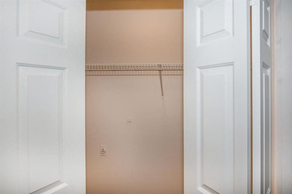 a bathroom with a closet and a white door