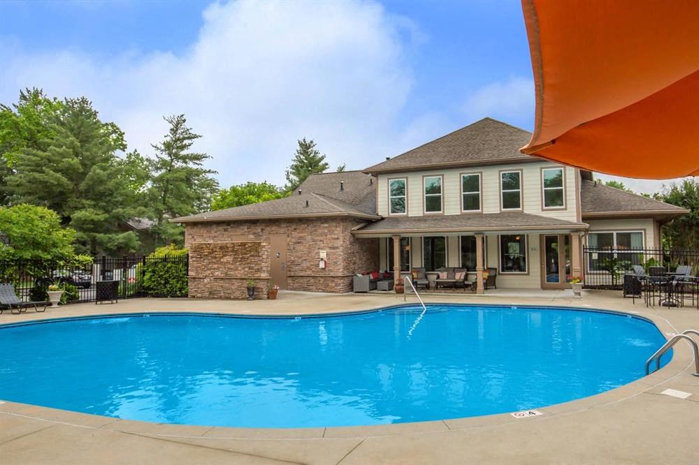 a large swimming pool in front of a house