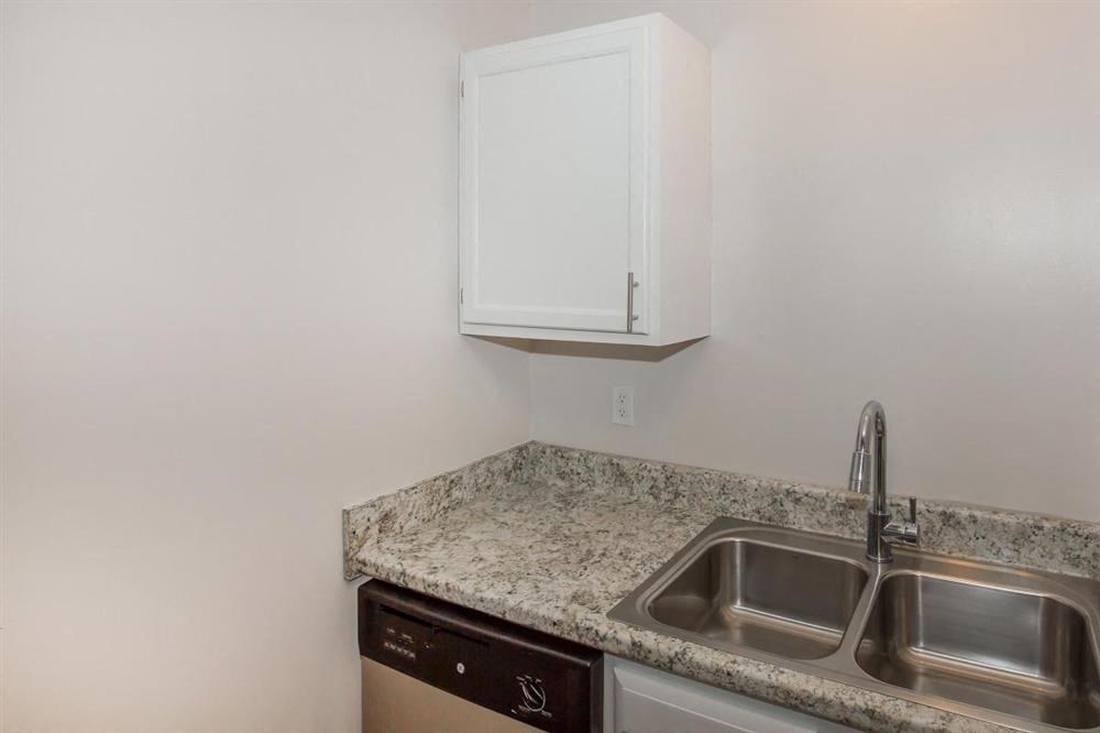 a kitchen with a sink and a cabinet