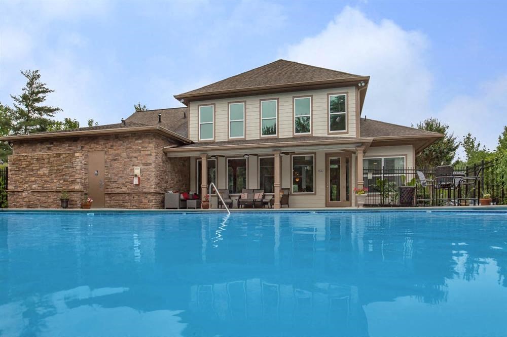 a large swimming pool in front of a house