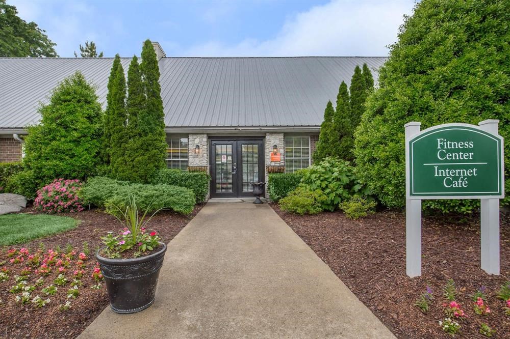 the entrance to fitness center lenient cafe with a sign in front of a building
