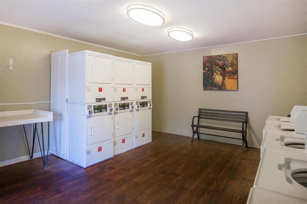 a room with a white refrigerator and a table
