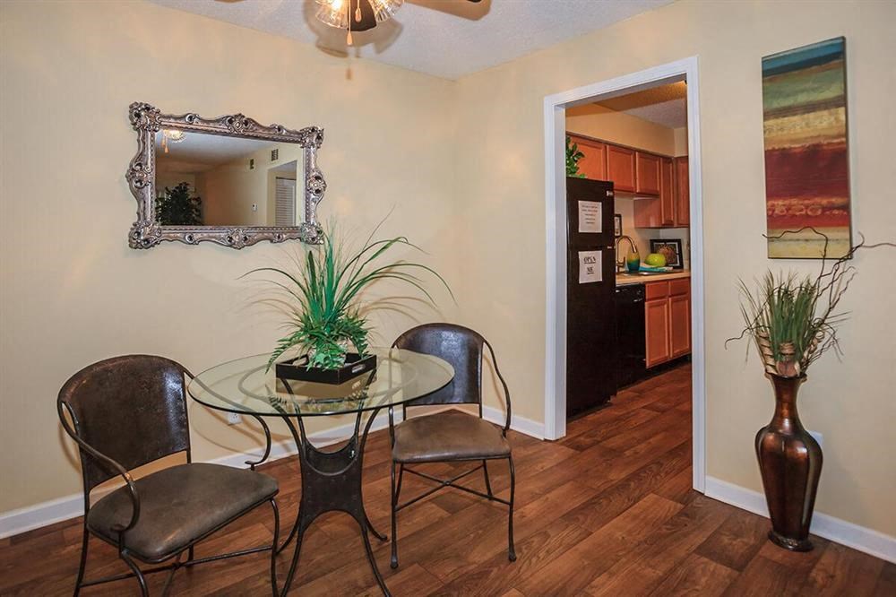 a dining room with a glass table and chairs