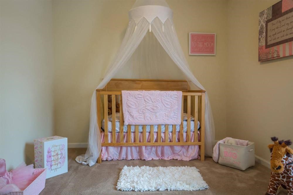 a baby room with a crib and a mosquito net