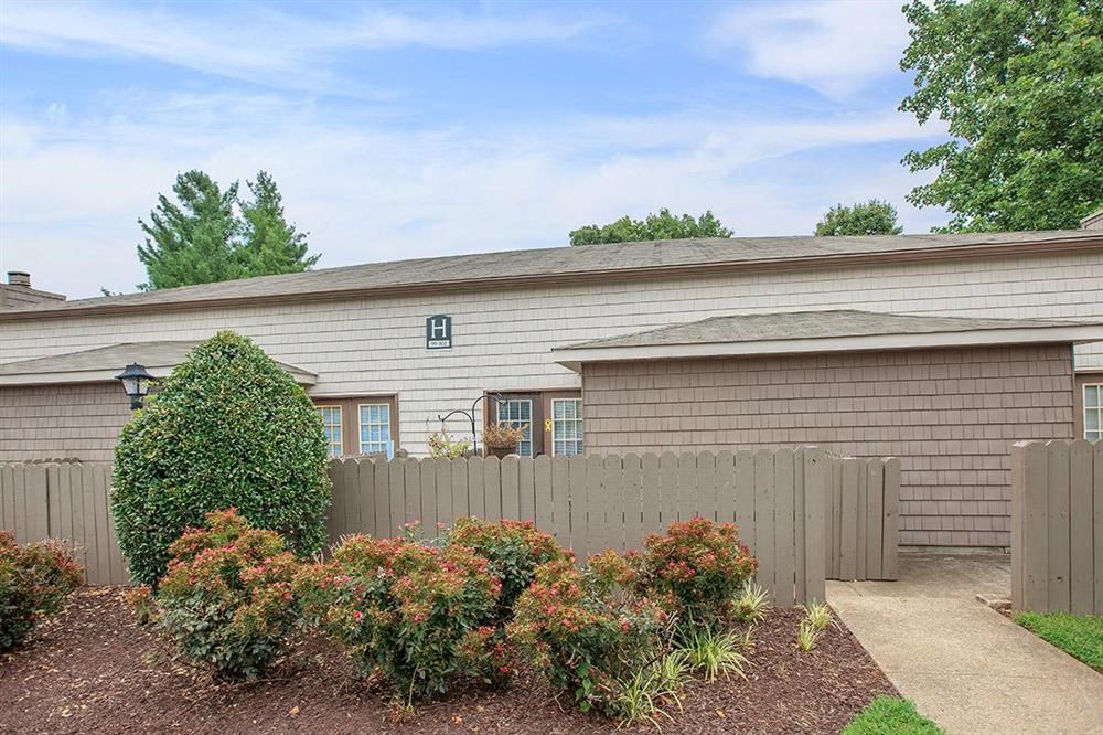 a house with a sidewalk and a fence