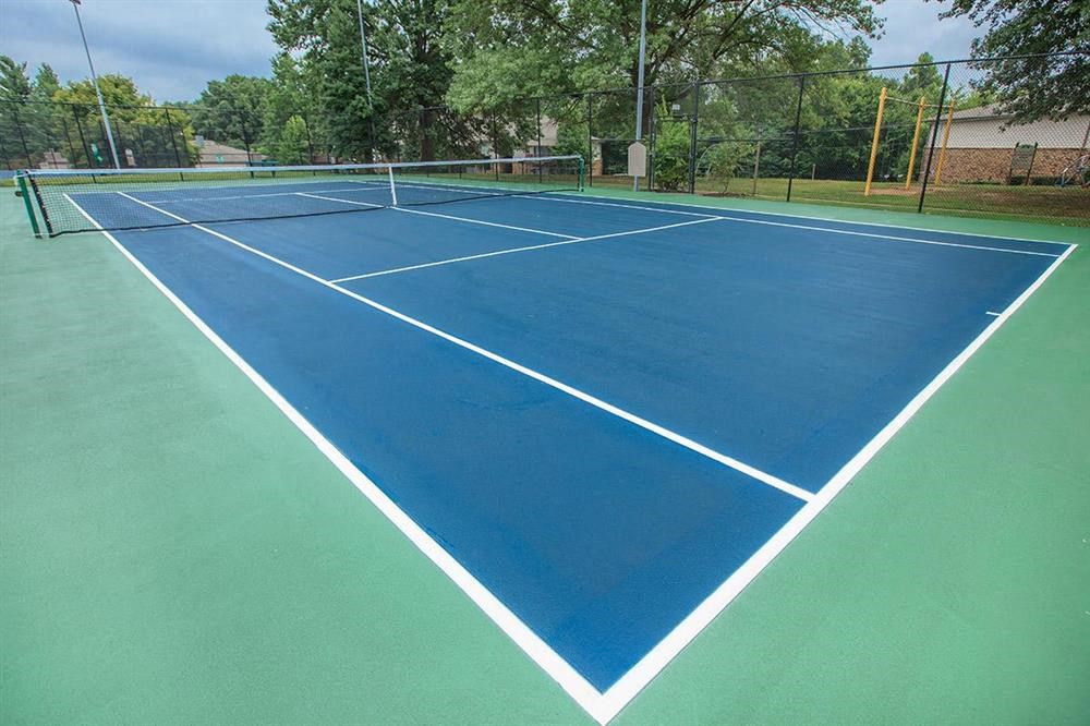 a blue and green tennis court with white lines on it