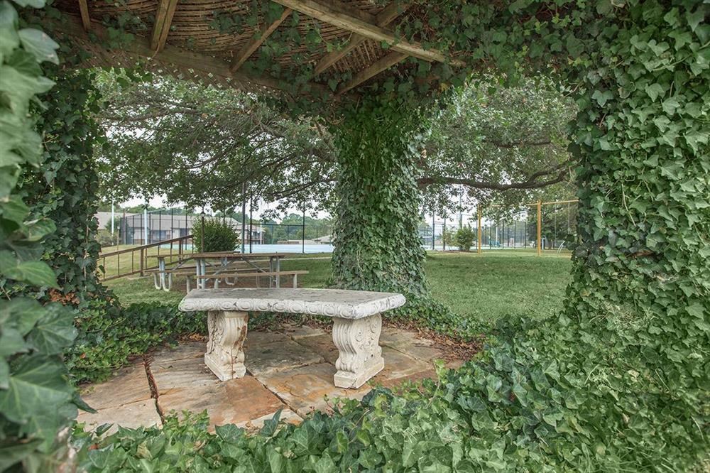 a stone picnic table sitting under a pavilion