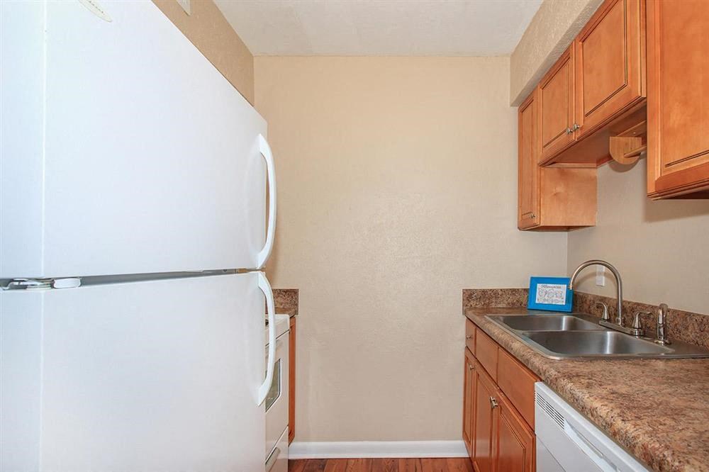 a kitchen with a refrigerator and a sink