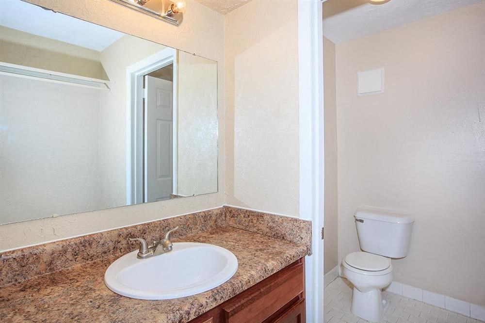 a bathroom with a sink and a toilet and a mirror