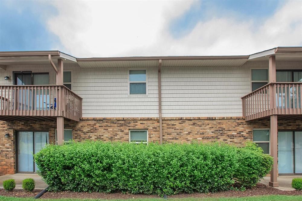 a building with a balcony and a brick wall