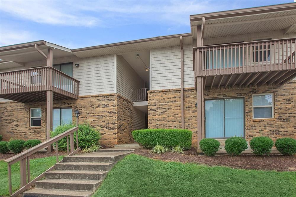 an apartment building with stairs and a balcony