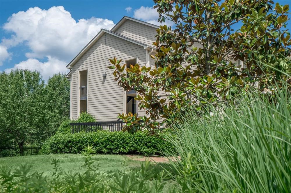a small house with a yard and a garden