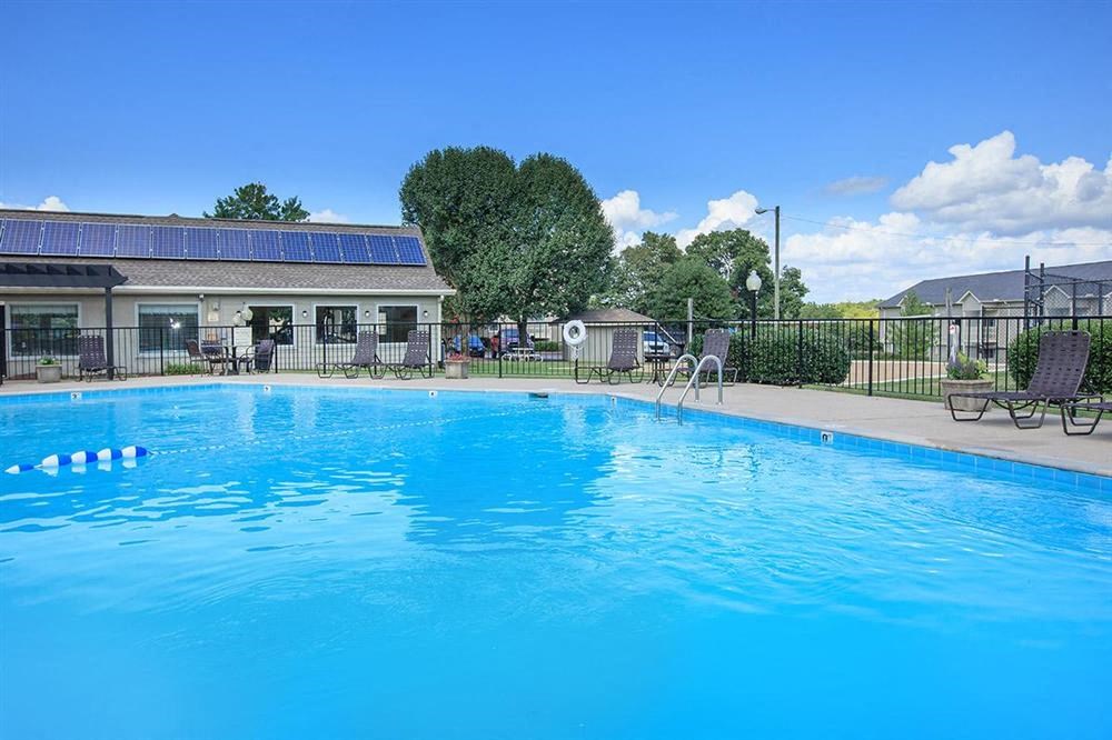a large swimming pool in front of a house