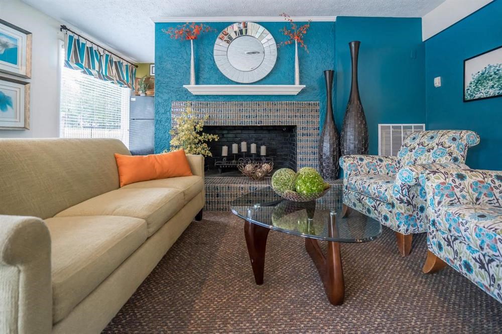 a living room with a couch and a table and a fireplace