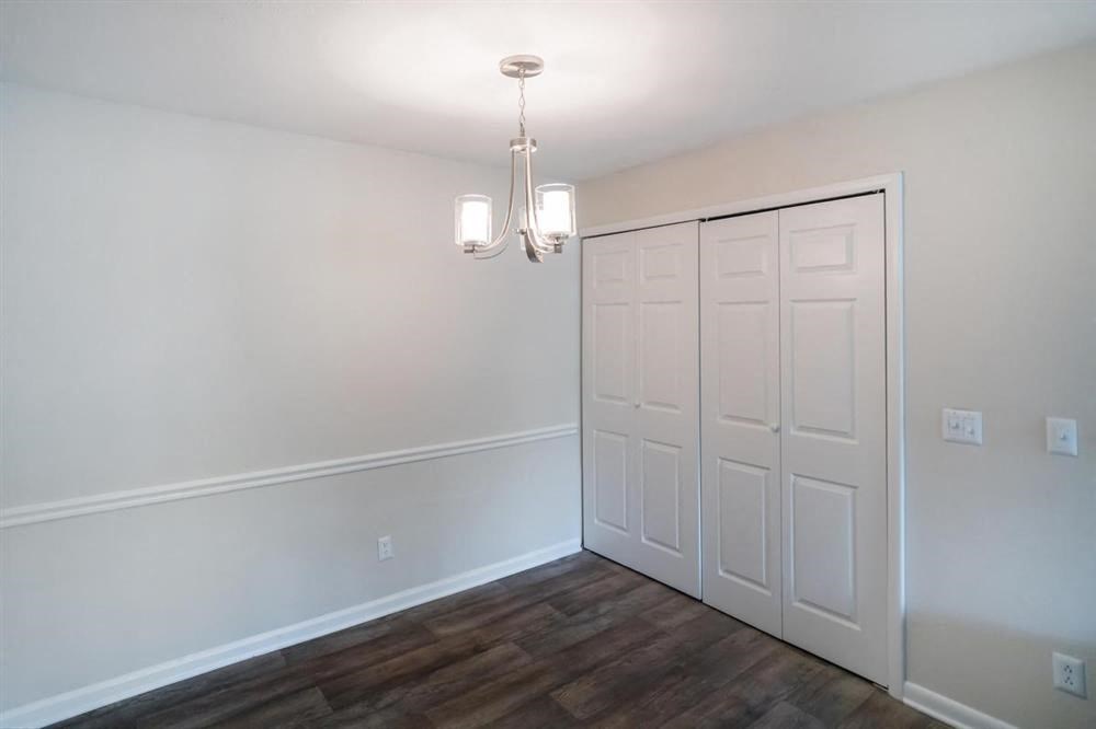 an empty living room with white walls and a white door