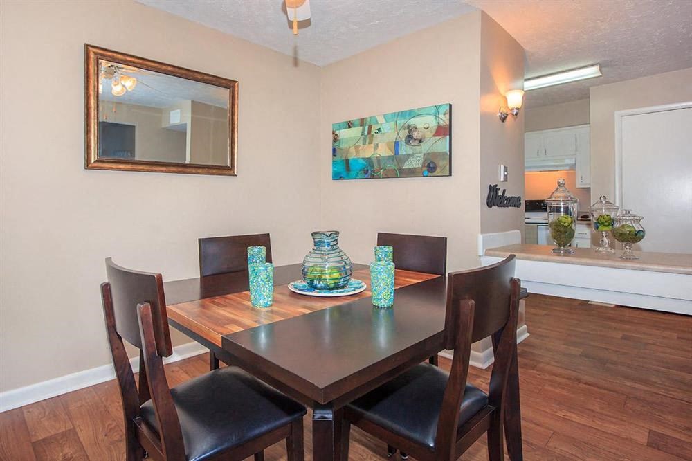 a dining room with a wooden table and chairs