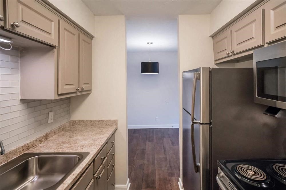 a kitchen with stainless steel appliances and white cabinets