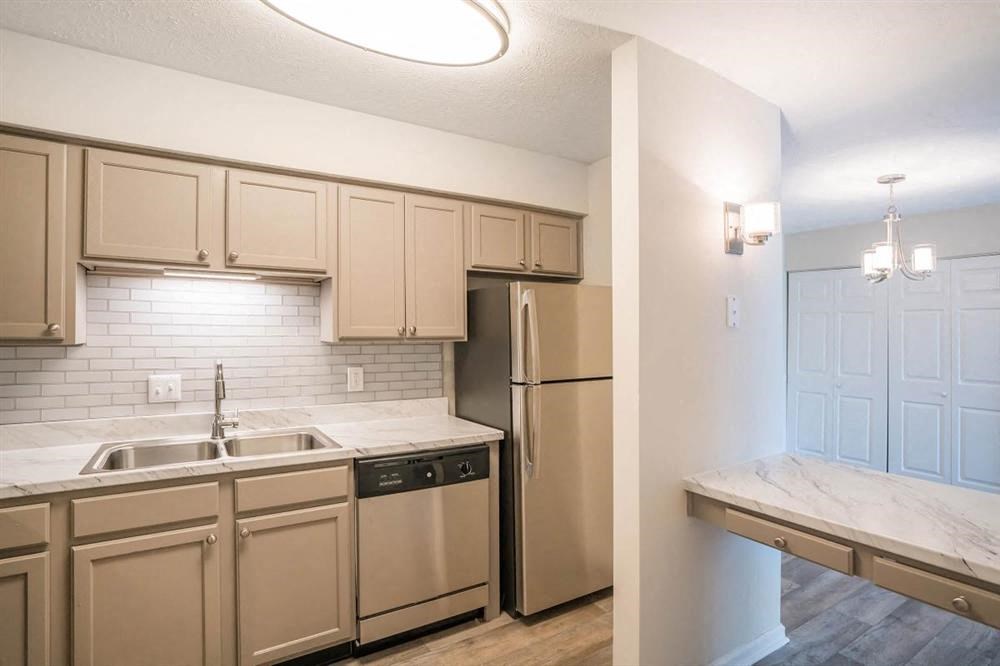 a kitchen with stainless steel appliances and white cabinets