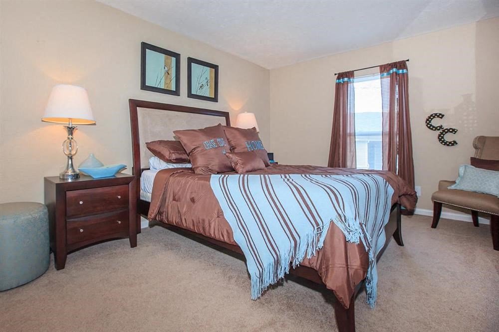 a bedroom with a bed and a window