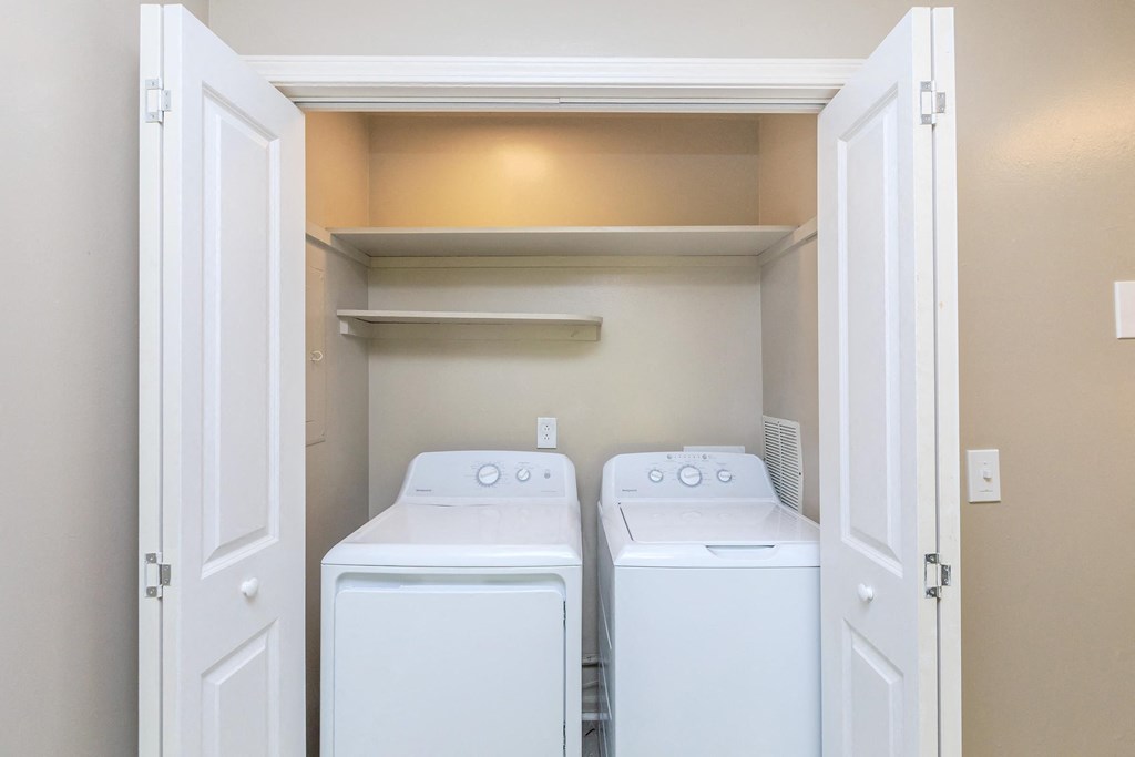 a washer and dryer in a laundry room with white doors
