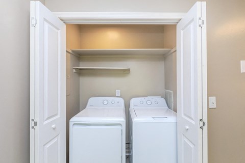 a washer and dryer in a laundry room with white doors
