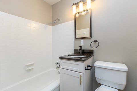 a bathroom with a sink toilet and a bath tub