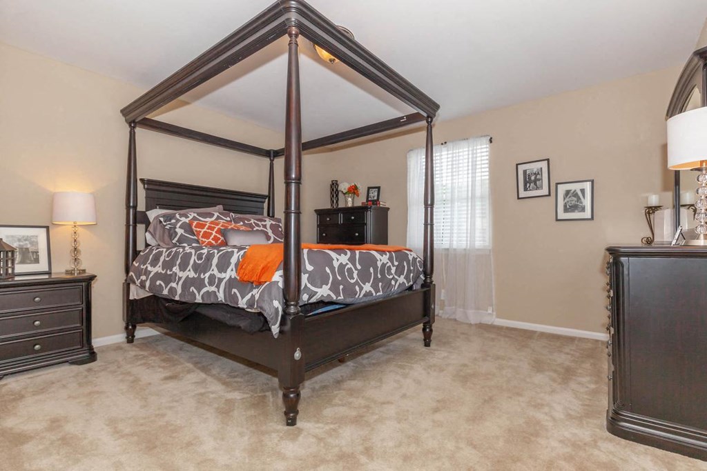 a bedroom with a bed and a dresser