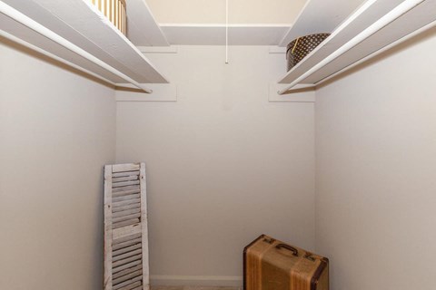 a white room with a ladder and a suitcase