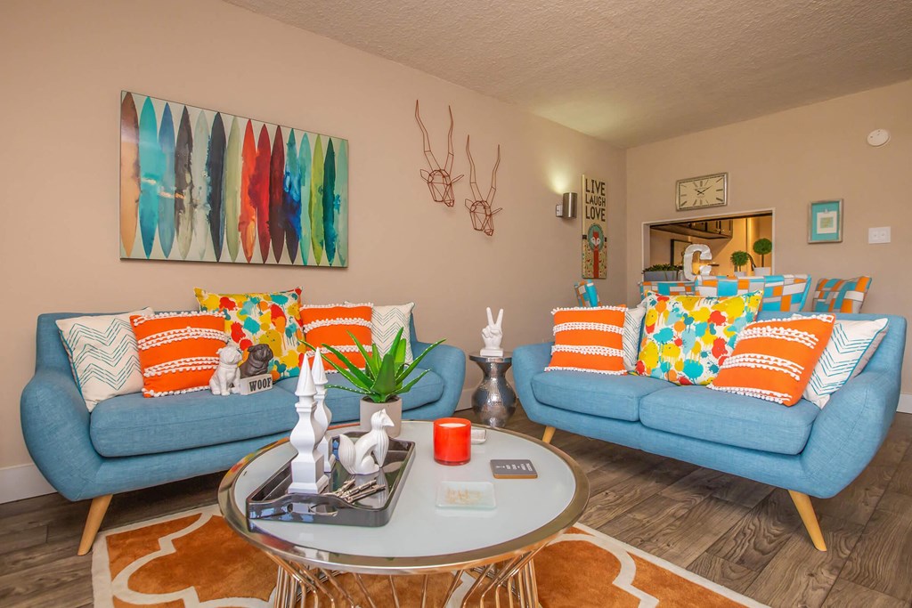 a living room with blue couches and a coffee table