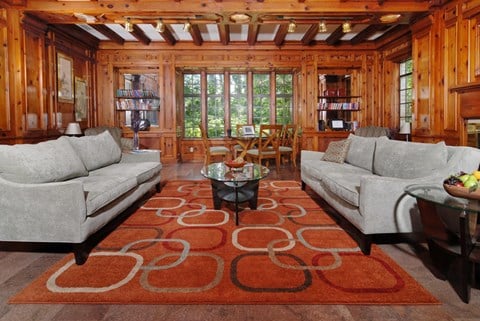 a living room with couches and a rug