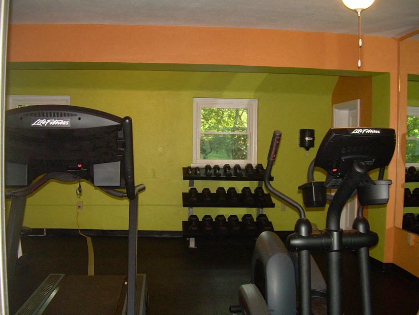 a workout room with weights and a window