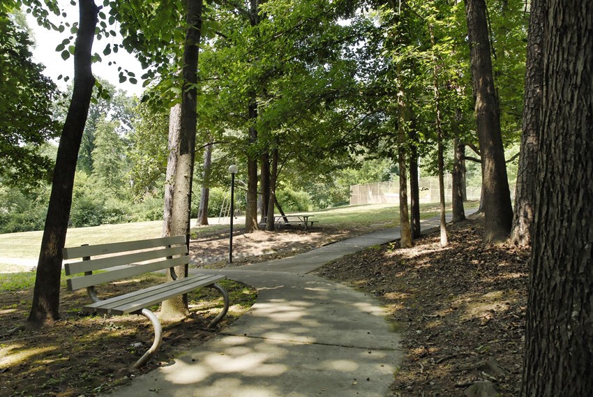 a park bench sitting next to a path