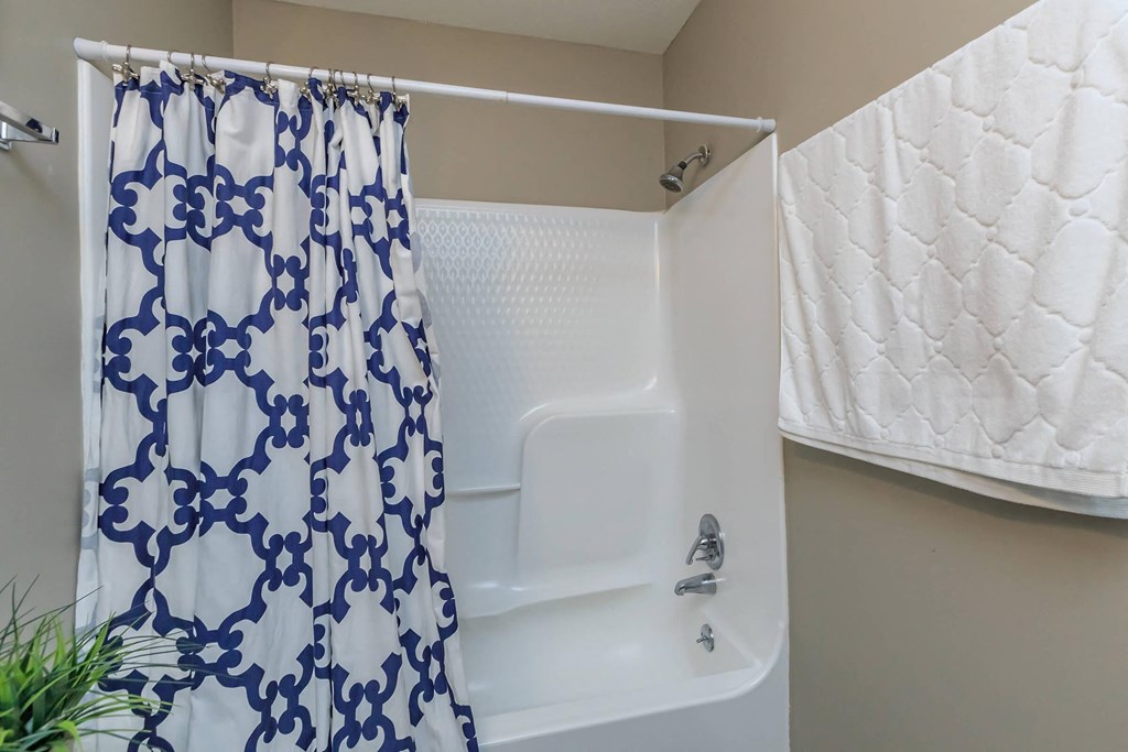 a bathroom with a shower and a sink