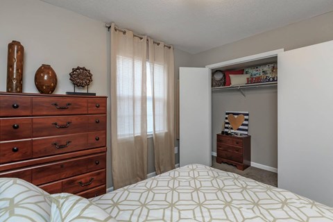 a bedroom with a bed and a dresser