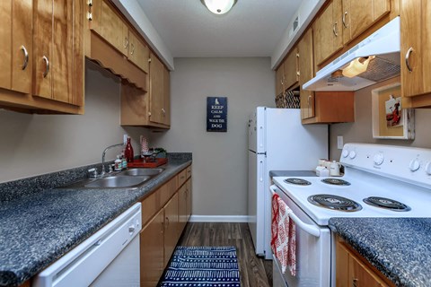 a kitchen with white appliances and granite counter tops
