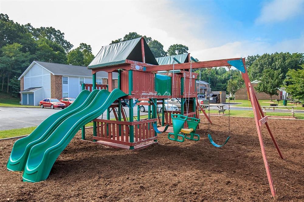a playground with a slide and a swing set