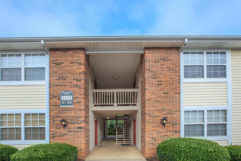a brick building with a balcony and a sign