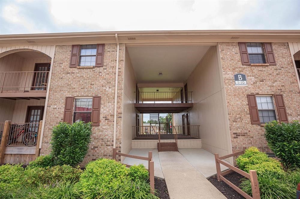 an apartment building with a walkway and a staircase
