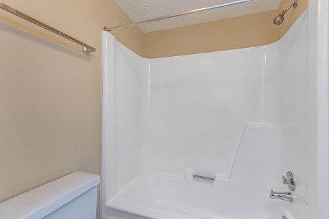 a bathroom with a shower and a toilet and a sink