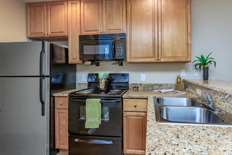 a kitchen with stainless steel appliances and granite counter tops