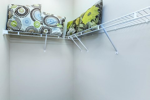 a pillow on a rack in a closet